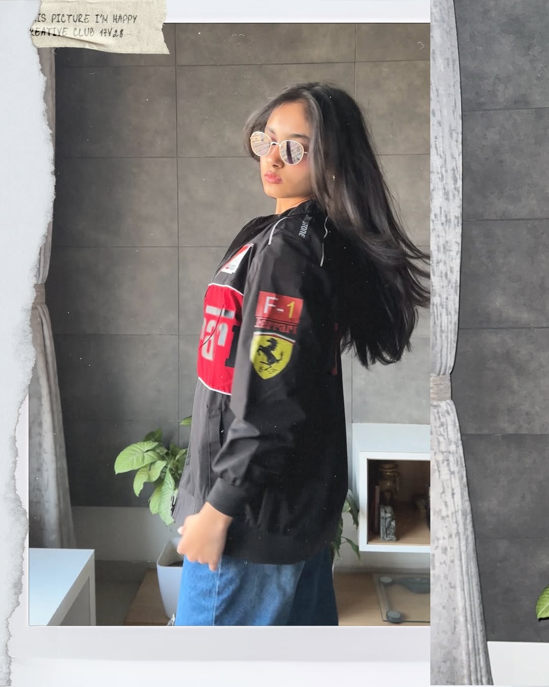 Side profile of the lightweight F1 motorcycle racing jacket showing the heavy F-1 Ferrari sleeve graphic. The model demonstrates the wide streetwear drape and drop-shoulder sleeve required for authentic Formula 1 clothing.