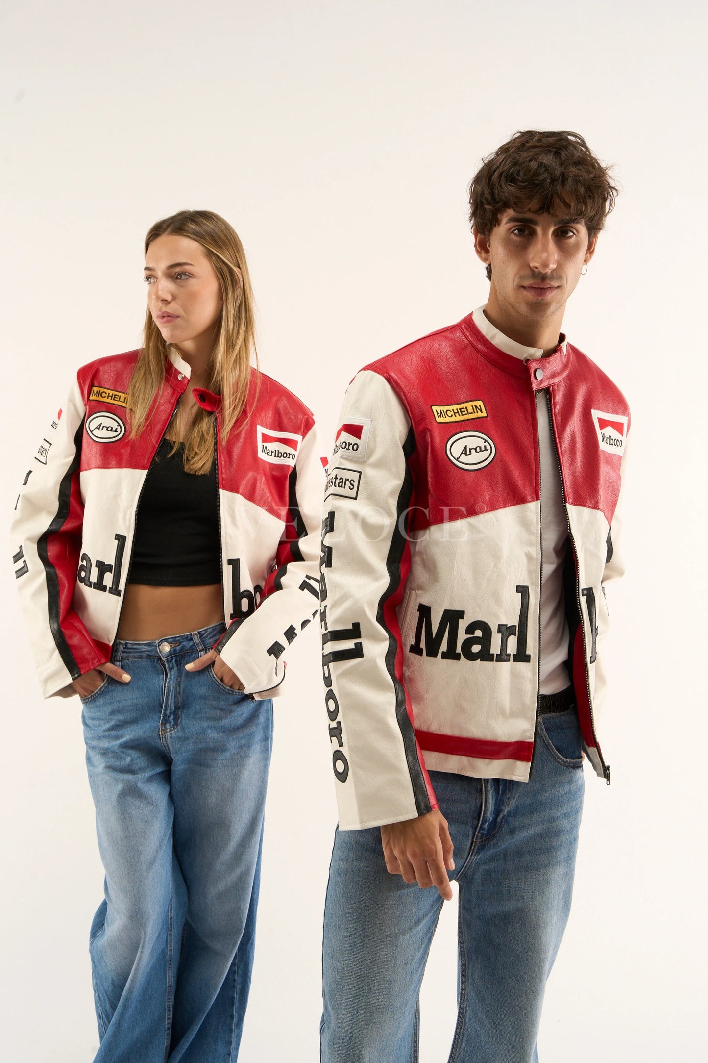 Two people wearing matching red, white Marlboro racing jacket showing detailed motorsport logos