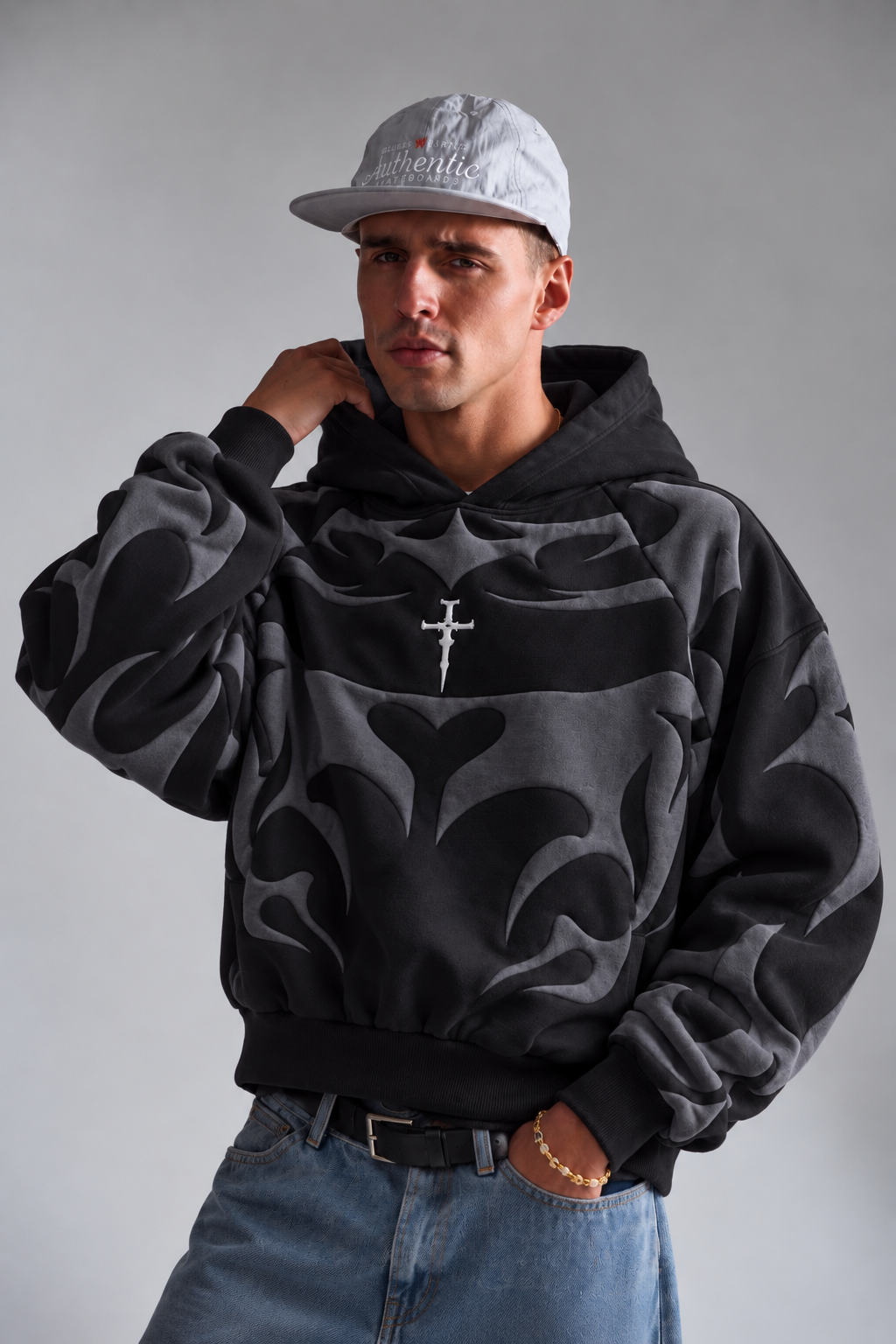Lifestyle shot of a boy in the black baggy winter hoodie, highlighting the clean stringless collar design
