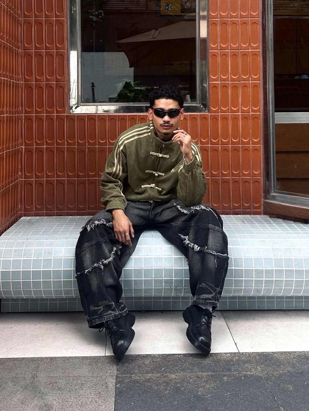 Direct front profile of a male model draped in the Olive Green Heavy Suede Bomber. The 420 GSM shell projects a highly masculine Gorpcore aesthetic anchored by the traditional toggle front buttons.