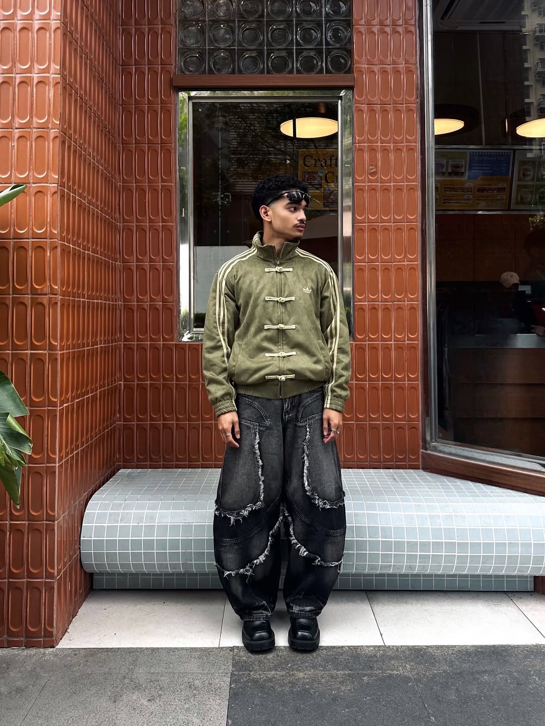 Dynamic walking candid of the male model wearing the Gigavibe Olive Green heavyweight jacket. Highlights exactly how the 420 GSM suede drapes naturally during heavy urban movement.