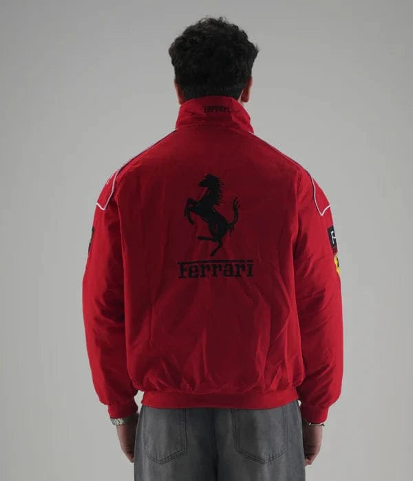 Full body shot of a boy wearing the vintage red Ferrari racing bomber jacket paired with relaxed-fit black trousers and skate sneakers