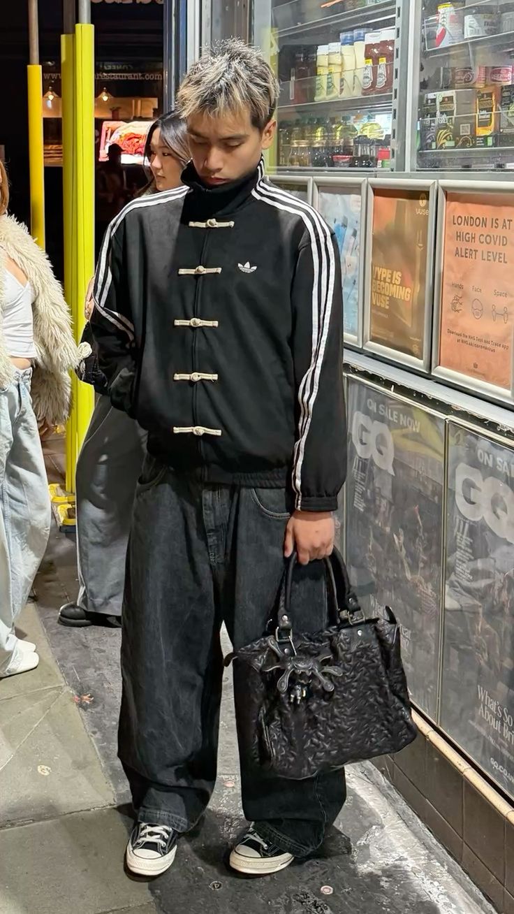 Men styling the oversized viral Black CNY Jacket Tang style from Gigavibe
