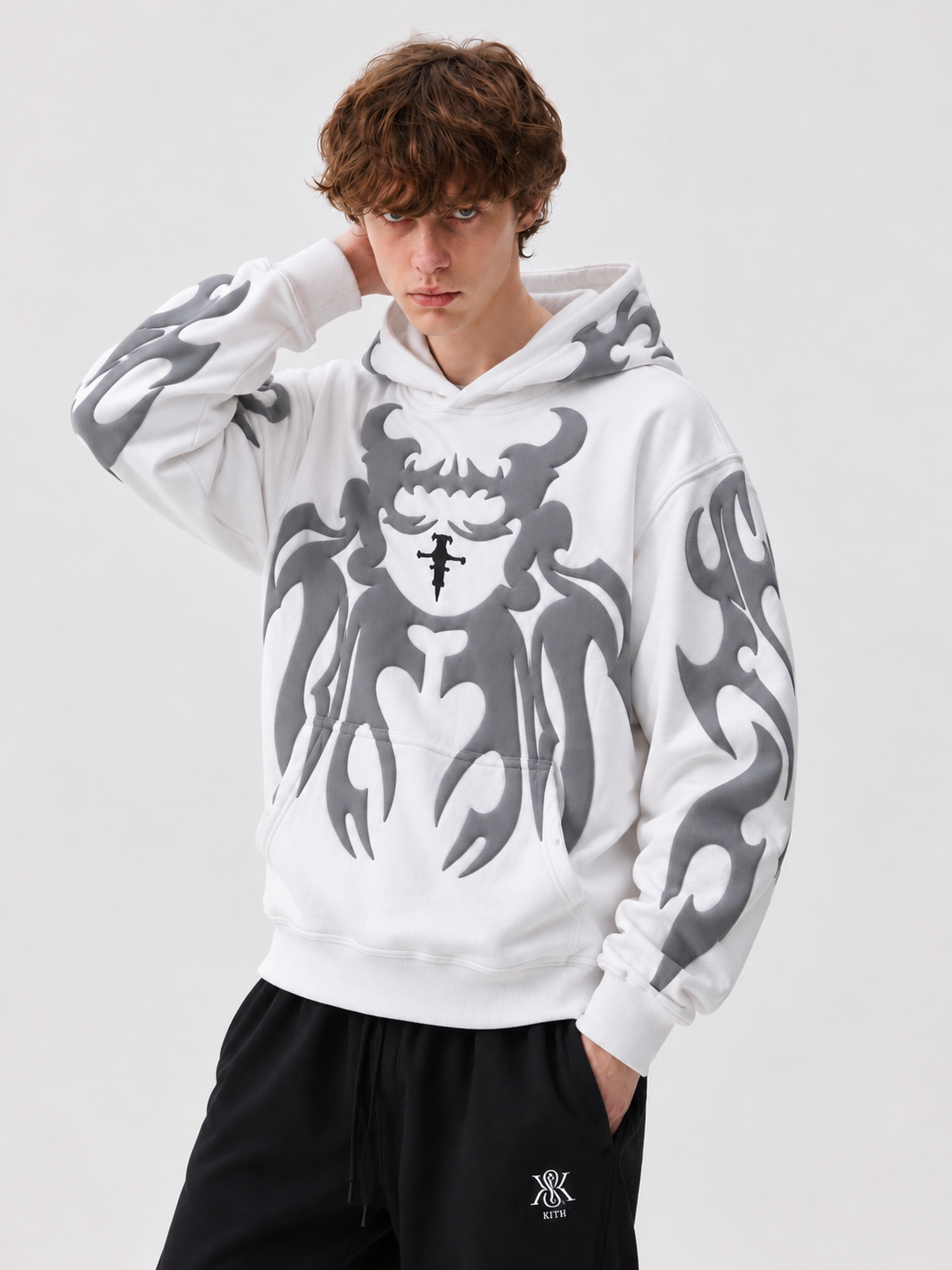Male model wearing the stark white Gigavibe depth hoodie, highlighting the high-contrast tribal puff prints