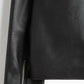 Full body lifestyle shot of the model wearing the black oversized boxy leather jacket layered over streetwear bottoms. Perfectly demonstrates the highly sought-after Opium darkwear proportions combining the wide minimalist moto jacket with baggy cargo pants.