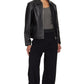 Full body lifestyle shot of the model wearing the black oversized cropped jacket open over a streetwear base layer