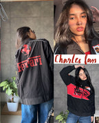 Back view collage of the Scuderia Ferrari jacket highlighting the massive red Ferrari horse graphic print and stylized Charles signature. Emphasizes the rich graphic saturation and vintage motorsport clothing India heritage.