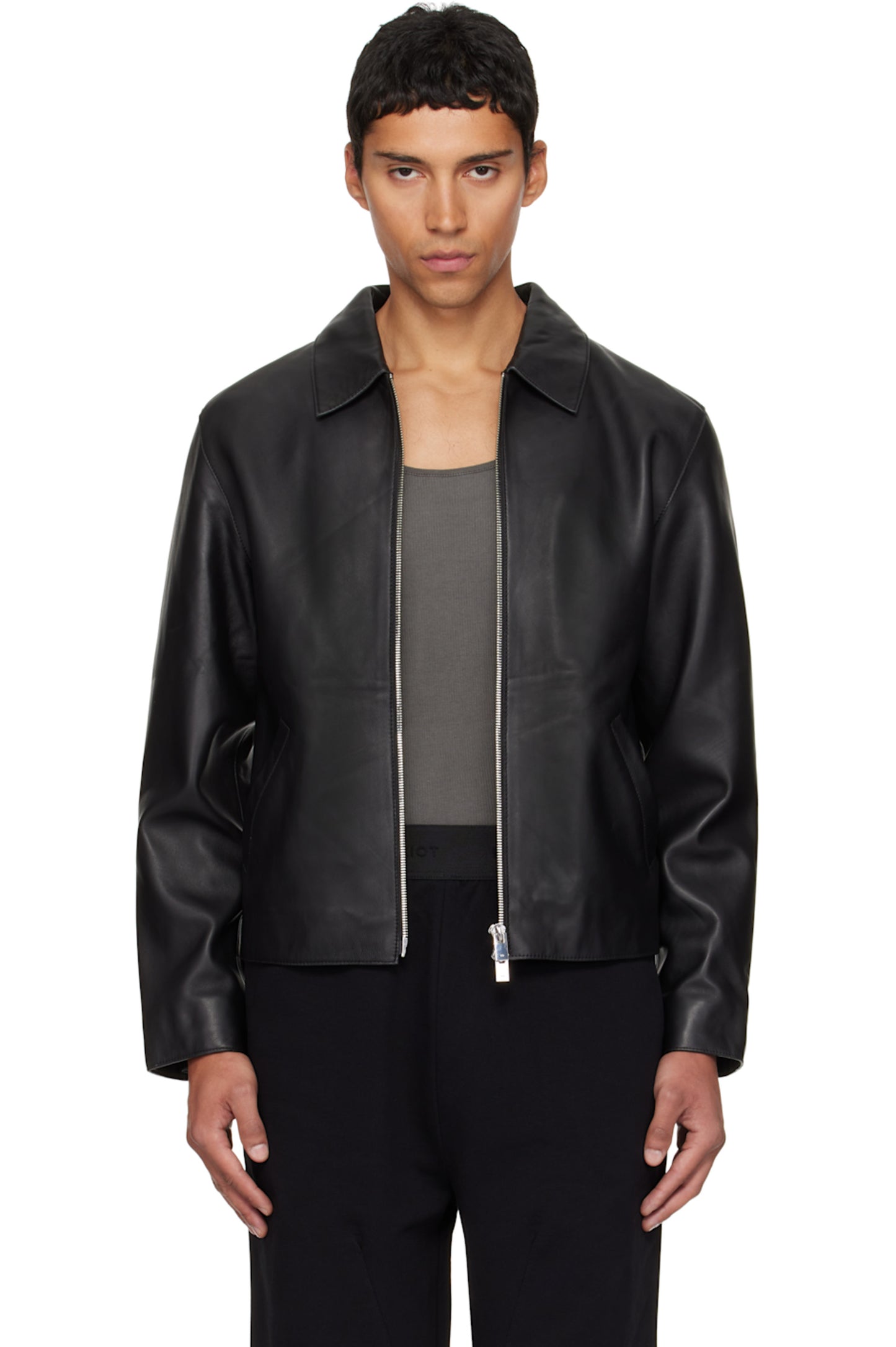Direct front view of the Unisex Cropped Leather Jacket in matte black at Gigavibe. The model demonstrates the premium vegan leather drape, showing the exposed silver front zipper and the classic boxy proportions essential for modern darkwear fashion in India.