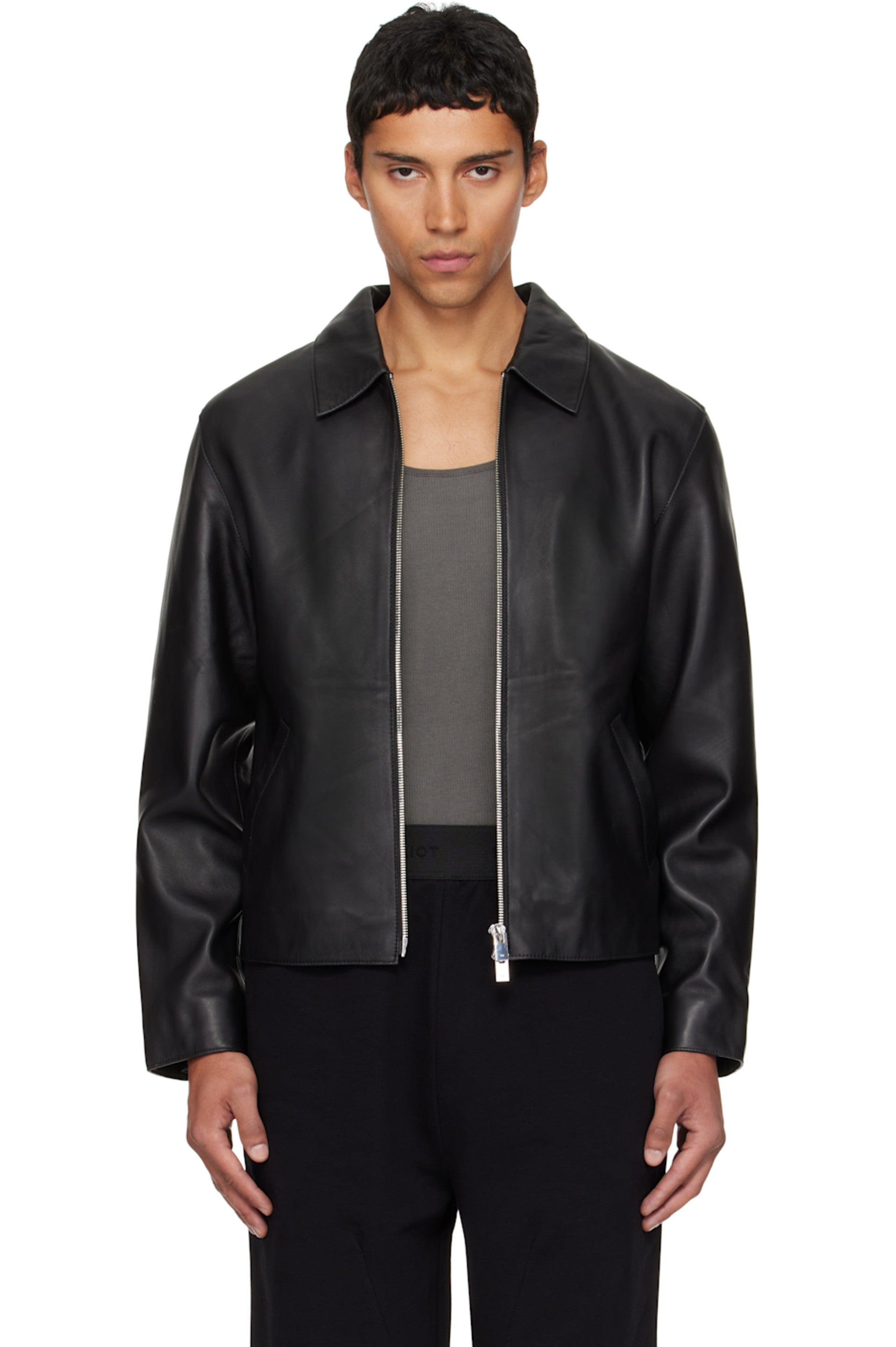 Direct front view of the Unisex Cropped Leather Jacket in matte black at Gigavibe. The model demonstrates the premium vegan leather drape, showing the exposed silver front zipper and the classic boxy proportions essential for modern darkwear fashion in India.