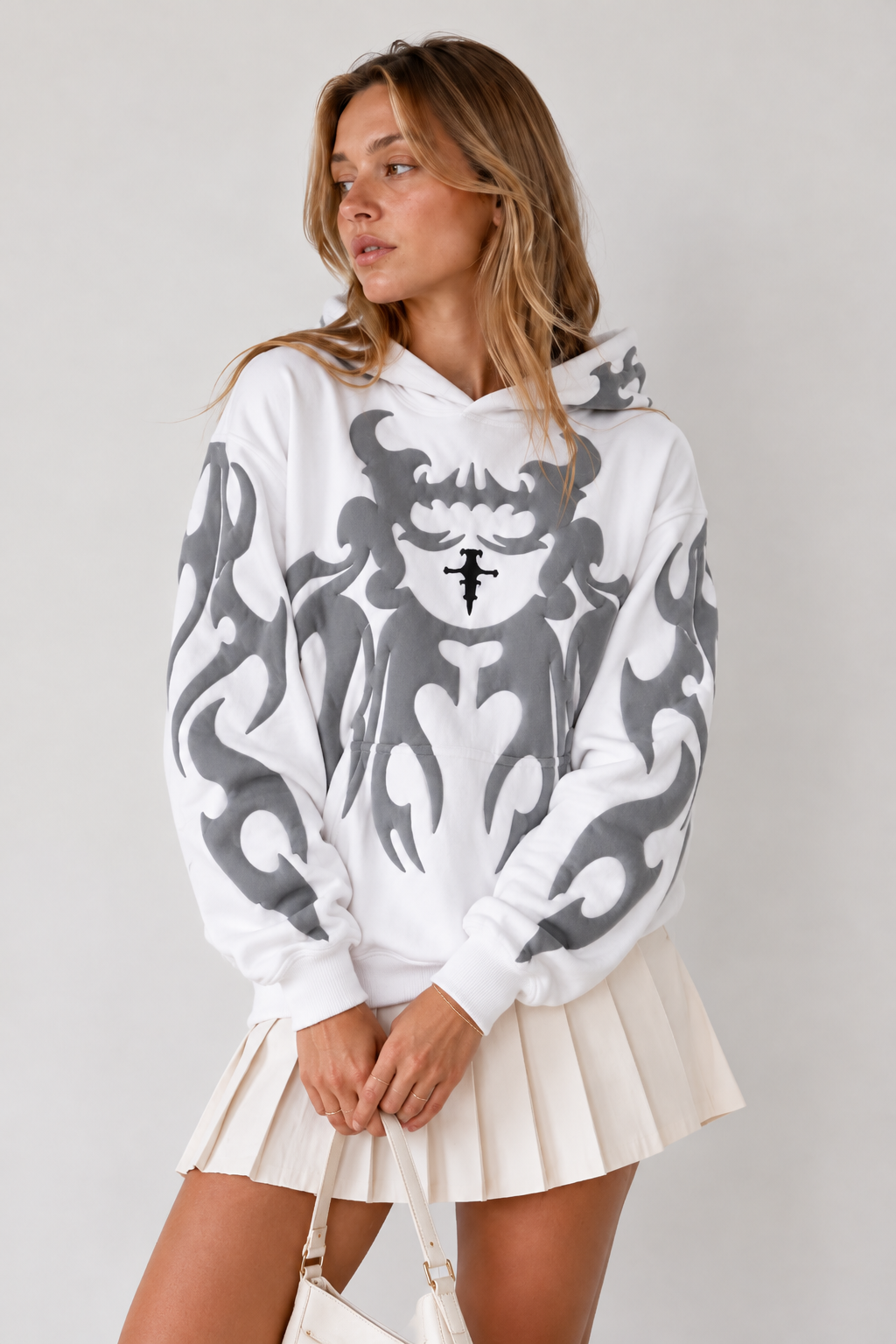 Lifestyle shot of the girl in the white winter hoodie, highlighting the minimalist hood and premium warmth