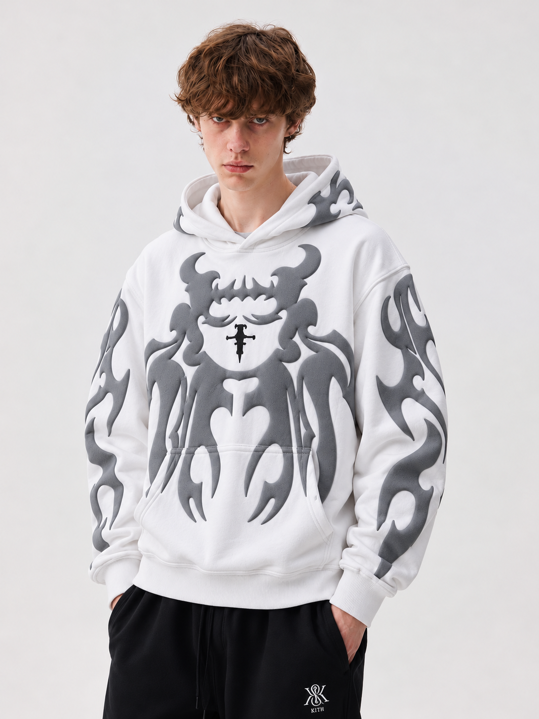 Streetwear styling of the white loosefit hoodie on a boy, showing how the thick fleece creates a highly structured aesthetic