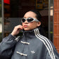 Frontal body angle of the female model enveloped in the Dark Grey Knot Bomber. Effortlessly captures the trending "model off-duty" runway aesthetic by mixing massive oversized layers with tight base garments.