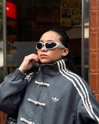 Frontal body angle of the female model enveloped in the Dark Grey Knot Bomber. Effortlessly captures the trending "model off-duty" runway aesthetic by mixing massive oversized layers with tight base garments.