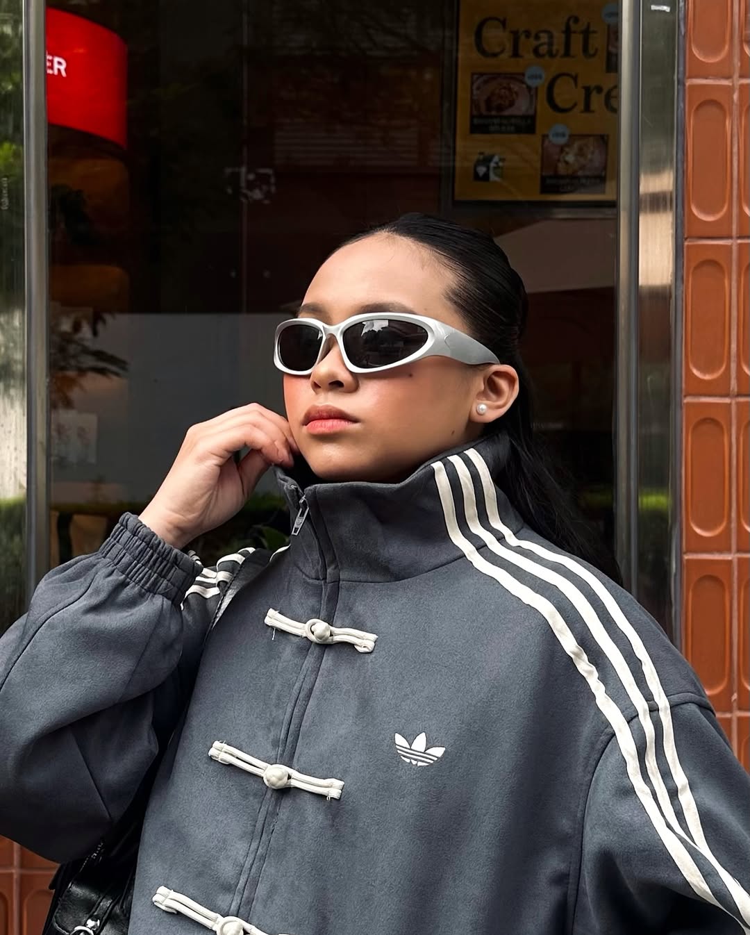 Frontal body angle of the female model enveloped in the Dark Grey Knot Bomber. Effortlessly captures the trending "model off-duty" runway aesthetic by mixing massive oversized layers with tight base garments.