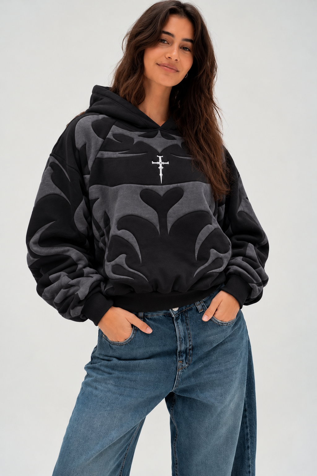 Female model styling the black Gigavibe graphic hoodie, emphasizing the comfortable Y2K drop-shoulder fit