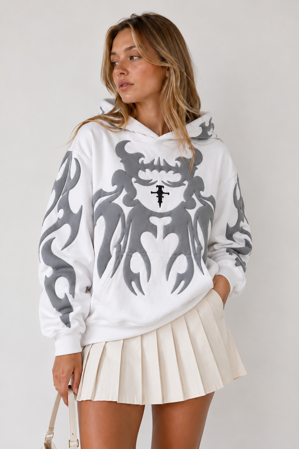 Female model rocking the crisp white Gigavibe graphic hoodie, demonstrating the versatile unisex baggy fit