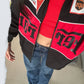 lose-up of the Y2K streetwear Ferrari F1 jacket in black, worn open over a red crop top. Features the breathable micro-mesh red lining and striking high-density chest graphics for aesthetic motorsport clothing India.